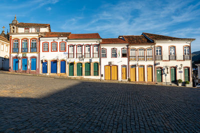 Exterior of building by street against sky