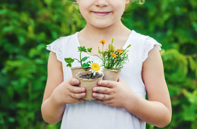 Midsection of woman holding flowers