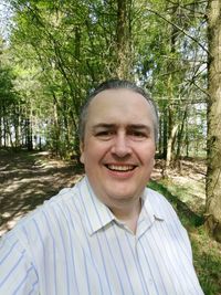 Portrait of smiling man in forest