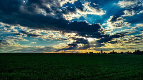 Scenic view of field against sky during sunset