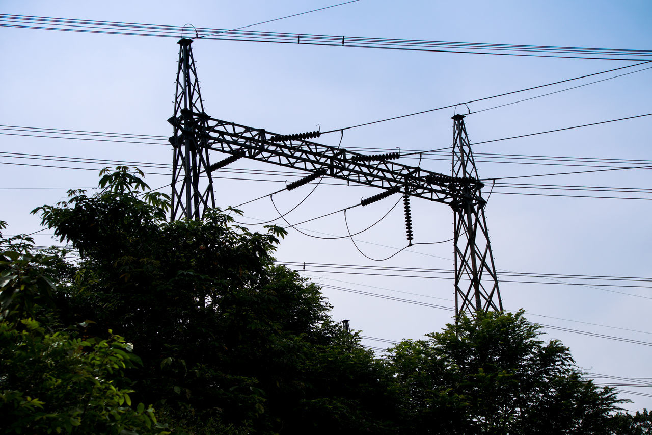 cable, electricity, technology, electricity pylon, power supply, power line, power generation, tower, tree, sky, overhead power line, nature, plant, no people, transmission tower, low angle view, outdoor structure, line, silhouette, complexity, electrical supply, outdoors, architecture, public utility, day, communication, built structure