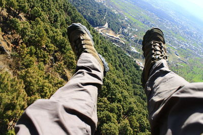 Low section of man standing on mountain