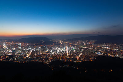 Aerial view of illuminated city at night