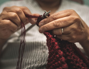 Midsection of woman knitting wool