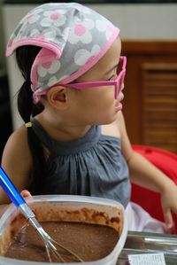 Close-up of cute girl preparing food on table