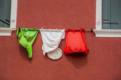 Clothes drying against white wall