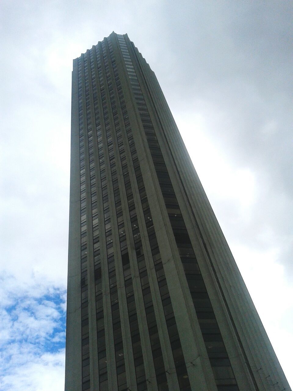 architecture, building exterior, built structure, modern, low angle view, skyscraper, office building, city, tall - high, sky, tower, cloud - sky, glass - material, building, reflection, tall, cloud, cloudy, day, city life