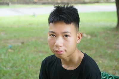 Portrait of young man sitting in park