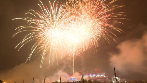 Low angle view of firework display at night