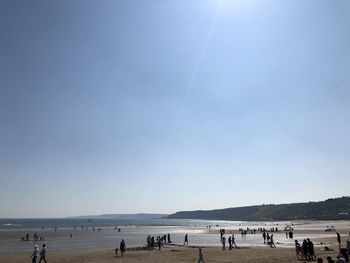 People at beach on sunny day