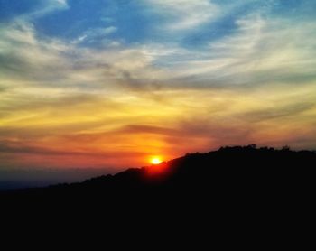 Scenic view of silhouette landscape against sky during sunset