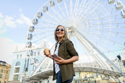 Low angle view of man holding umbrella