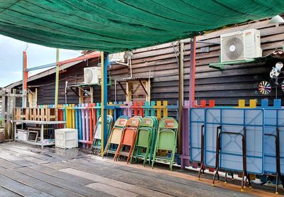 Empty chairs and tables against buildings