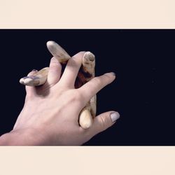 Close-up of woman hand against black background