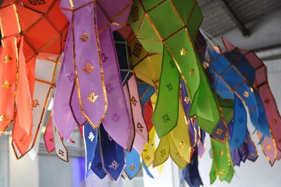Low angle view of multi colored paper lanterns hanging from ceiling