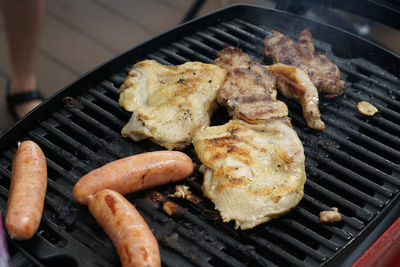 High angle view of meat on barbecue grill