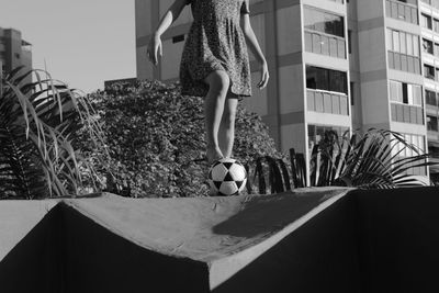 Low section of woman with soccer ball