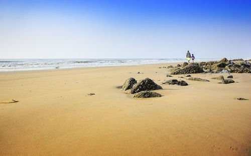 Scenic view of beach against clear sky