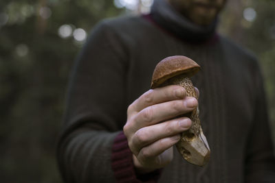 Hand holding mushroom