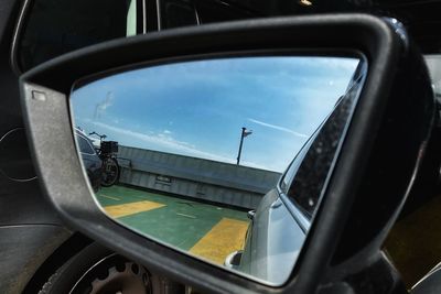 Reflection of sky on side-view mirror