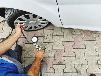 Low section of man with umbrella on car