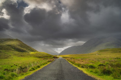 Road leading trough doolough valley, between mountain ranges, ireland