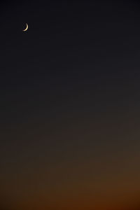 Low angle view of moon against sky at night