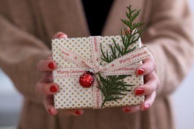 Midsection of woman holding christmas present