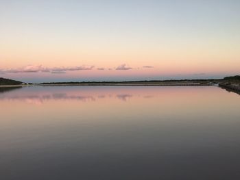 Scenic view of calm lake at sunset