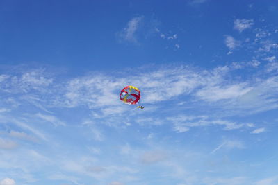 Low angle view of parachute against blue sky