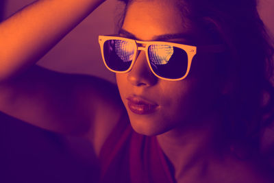 Close-up portrait of young woman wearing sunglasses