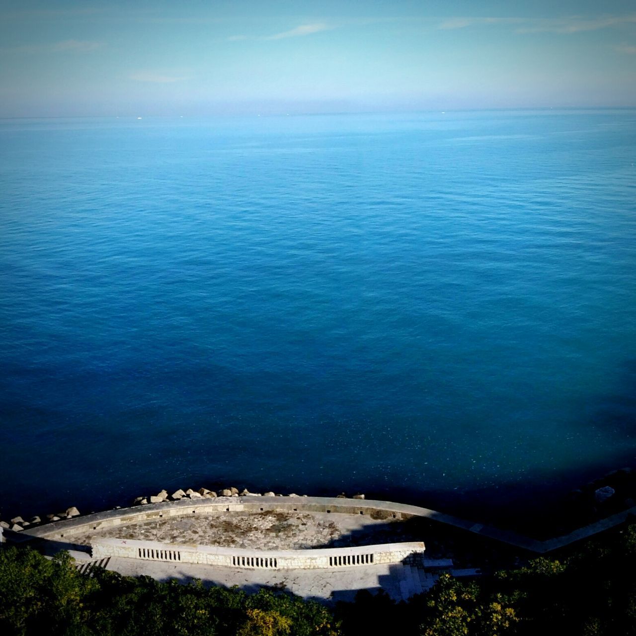 sea, water, high angle view, nature, no people, blue, outdoors, beauty in nature, horizon over water, architecture, built structure, tranquility, scenics, beach, day, building exterior, sky, cityscape