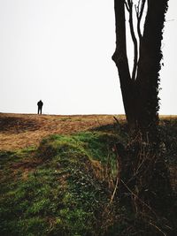 Man standing on field against clear sky