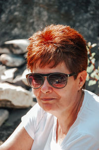 Portrait of young man wearing sunglasses standing outdoors