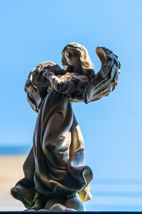 Low angle view of statue against sky