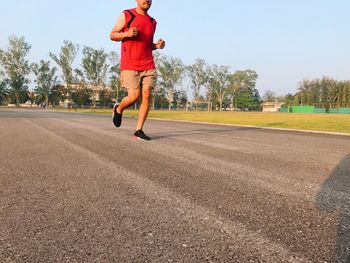 Full length of man running on plant against sky