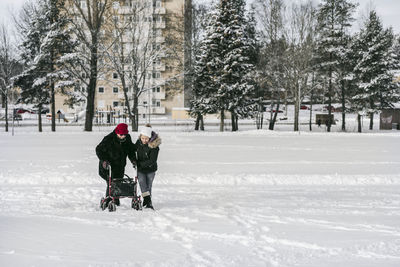 People in snow on field during winter