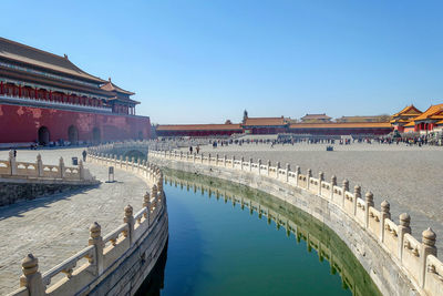 Panoramic view of buildings against clear blue sky