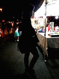 Woman standing at night