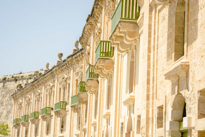 Low angle view of building in valletta water front against sky