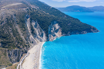 High angle view of sea and mountains against sky