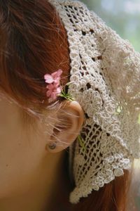 Close-up portrait of woman wearing flowers