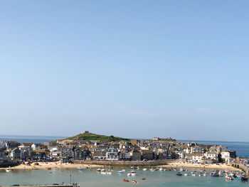 City by sea against clear sky