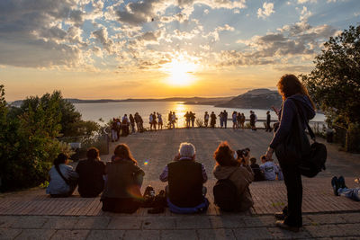 Rear view of people looking at sunset