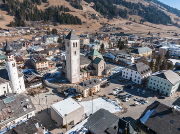 High angle view of townscape against mountain on sunny day during winter