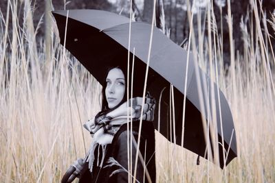 Portrait of young woman standing on grass