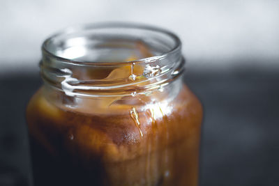 Close-up of iced tea in glass jar on table