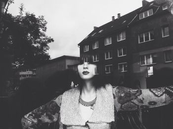 Portrait of woman standing in front of building