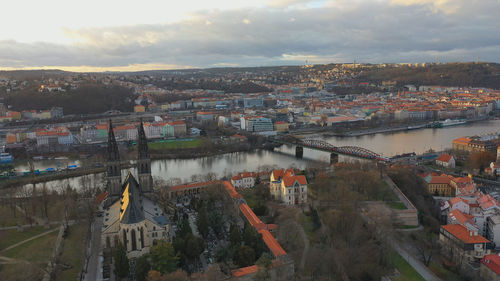 High angle view of river amidst buildings in city against sky