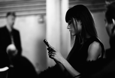 Young woman holding smart phone